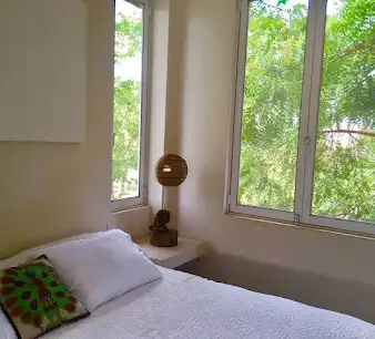 A bright Villa María guest room with garden views