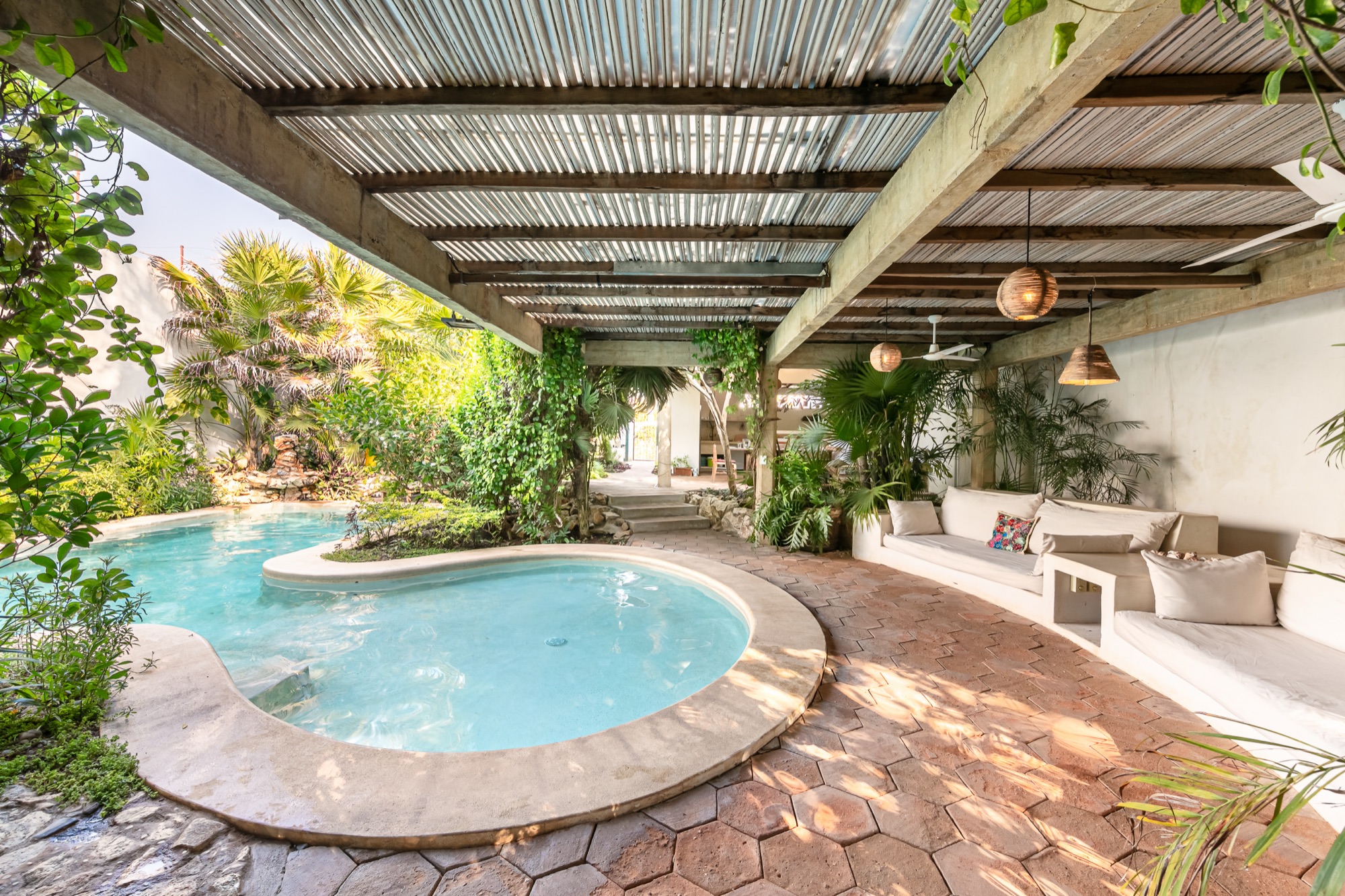 Villa María courtyard, pool, and palms