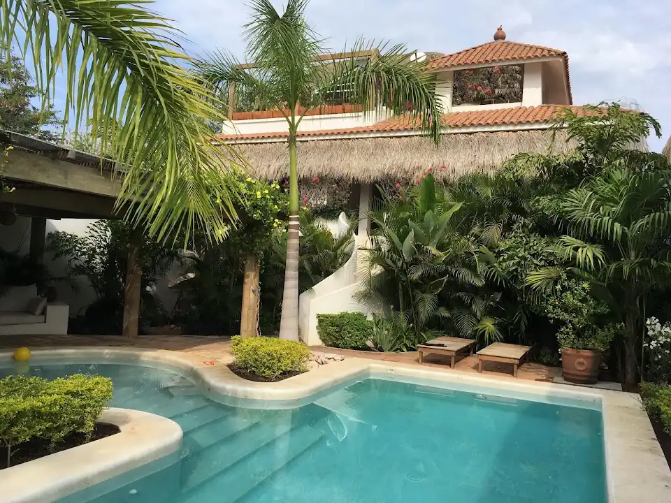 Villa María courtyard, pool, and palm-shaded terrace